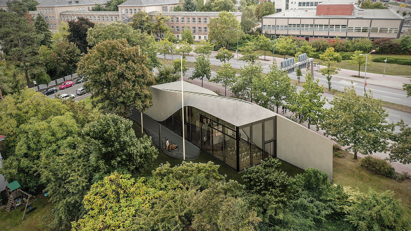Flaches, geschwungenes Betongebäude mit Glasfronten, eingebettet in grüne Bäume