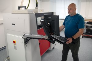 Druckvorgang ein Mann schaut aufs Bedienfeld einen Druckers