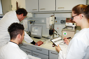 Fuel Technology Lab — Students conducting the experiment on a laptop and recording the data in a lab report