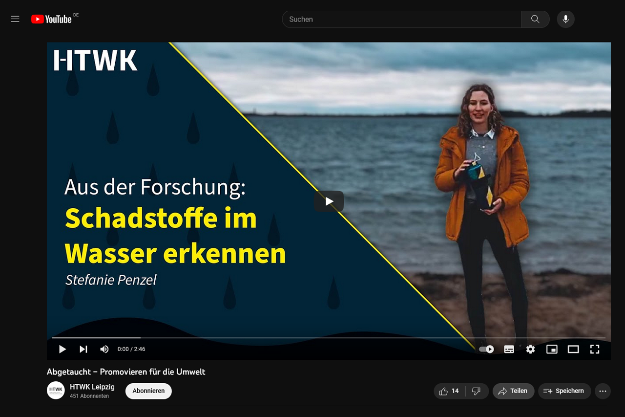 Still from the video – Stefanie is standing in front of the lake with a measuring device