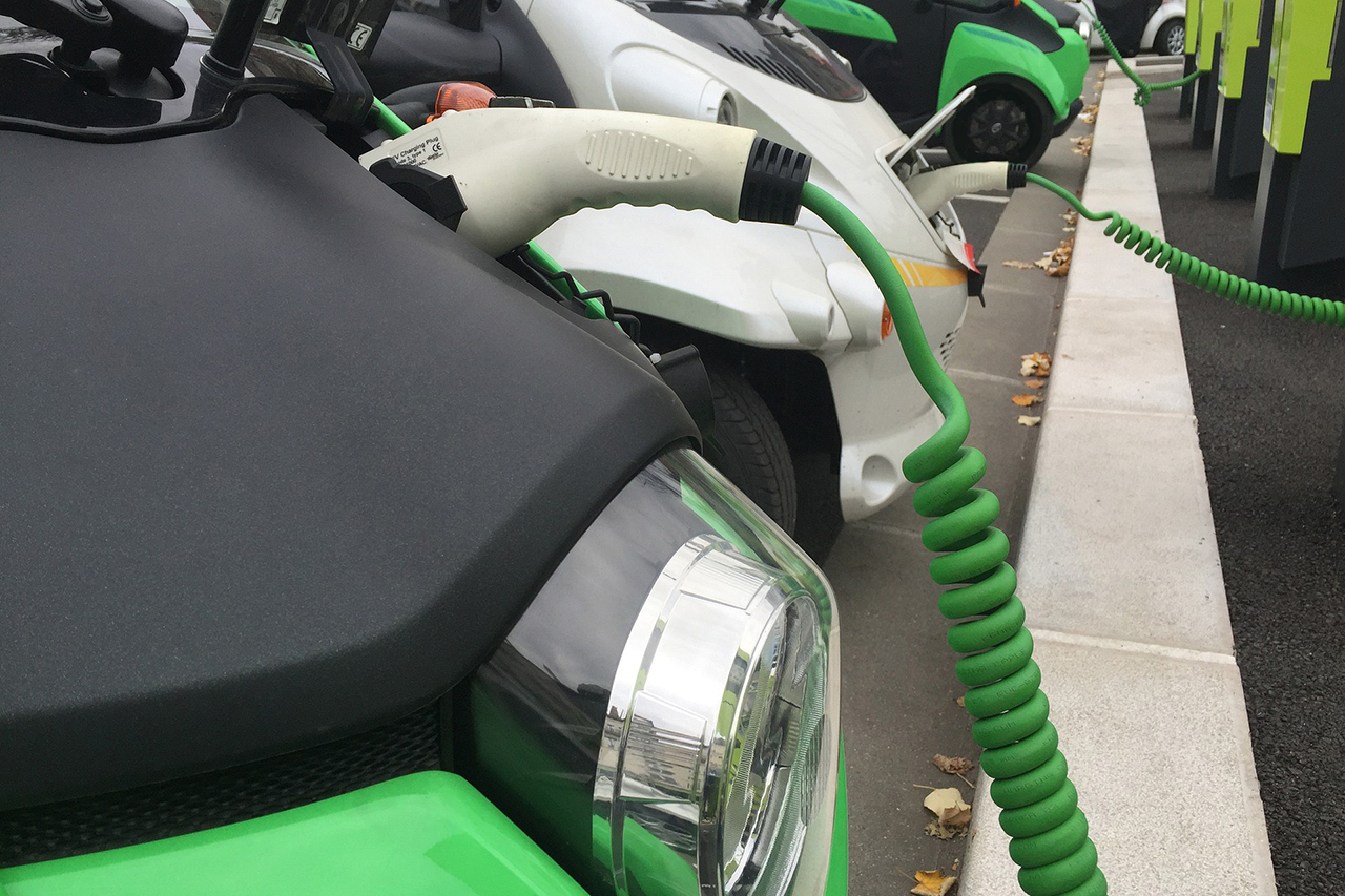 Close-up of charging cable on electric car being charged/link leads to project website