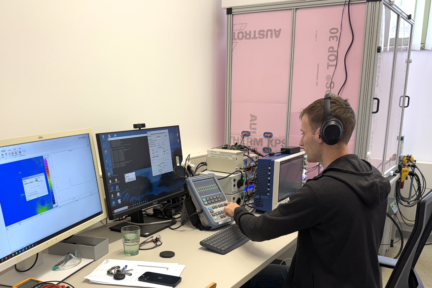 A laboratory engineer sits in front of monitors