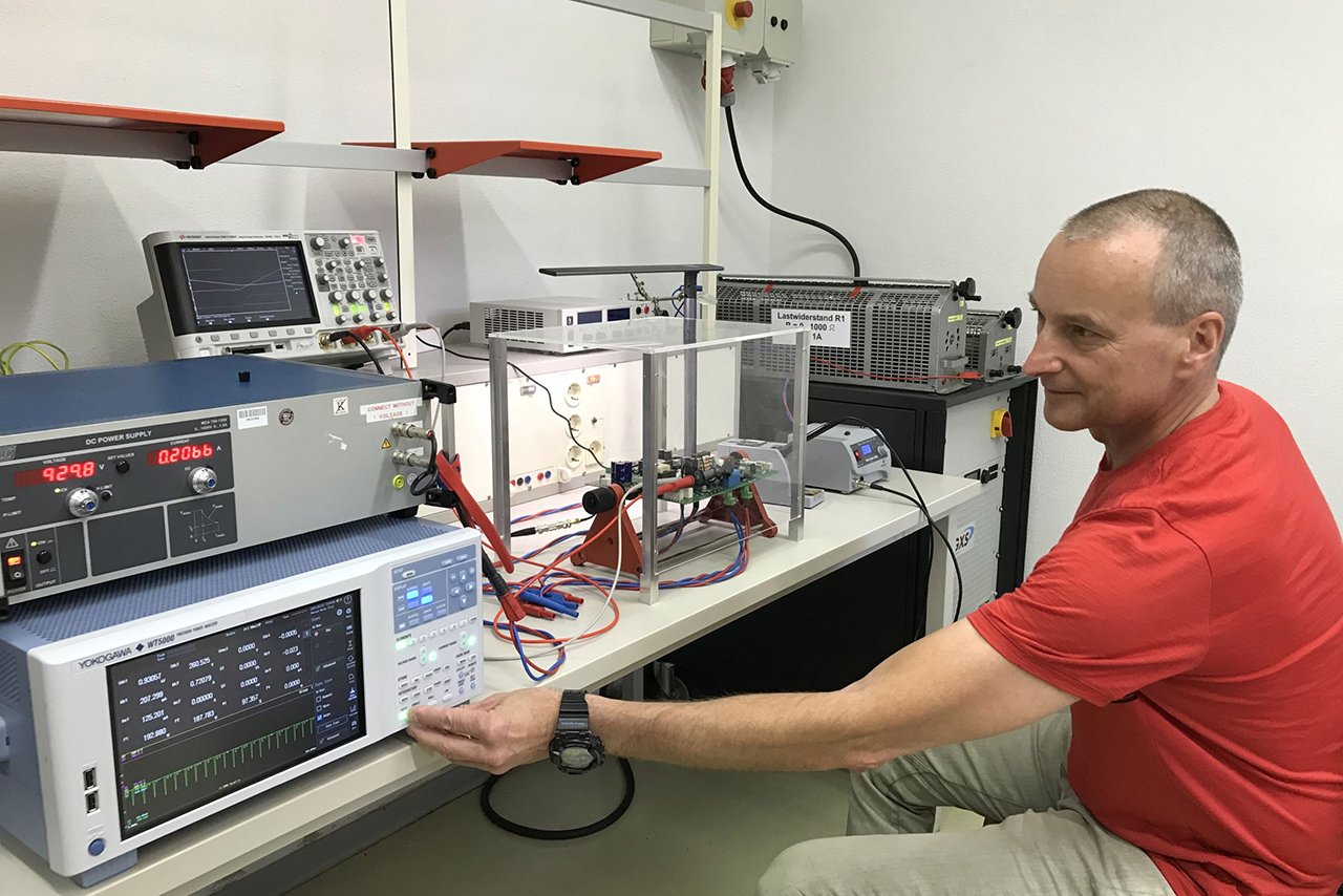 Prof. Komma is sitting in front of a control module