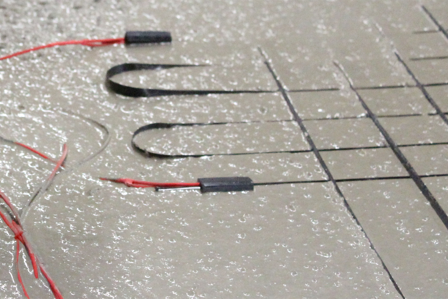 Cables and wires are embedded in liquid concrete; clicking the link takes you to the project website