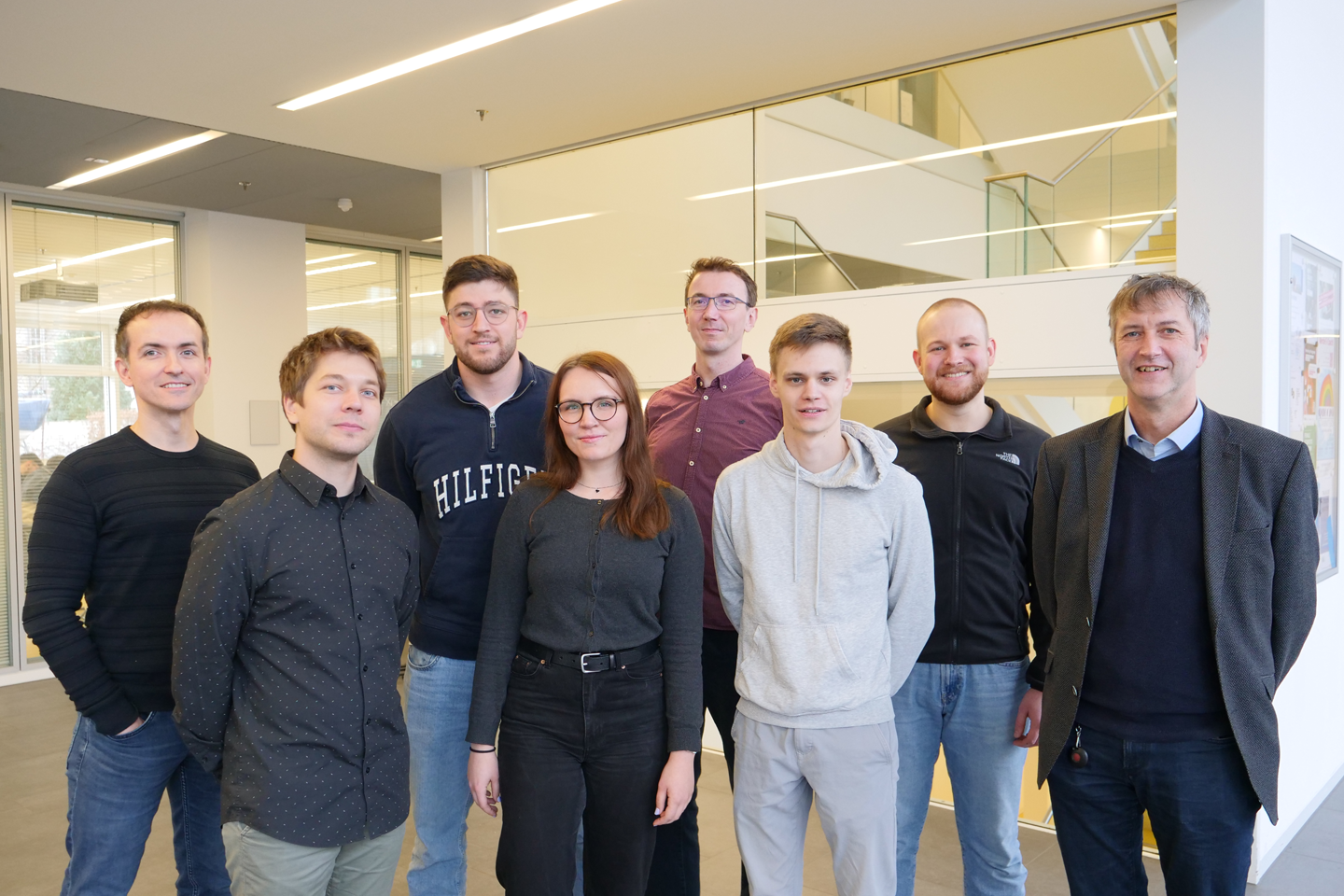 Group photo of the team, with everyone smiling slightly at the camera